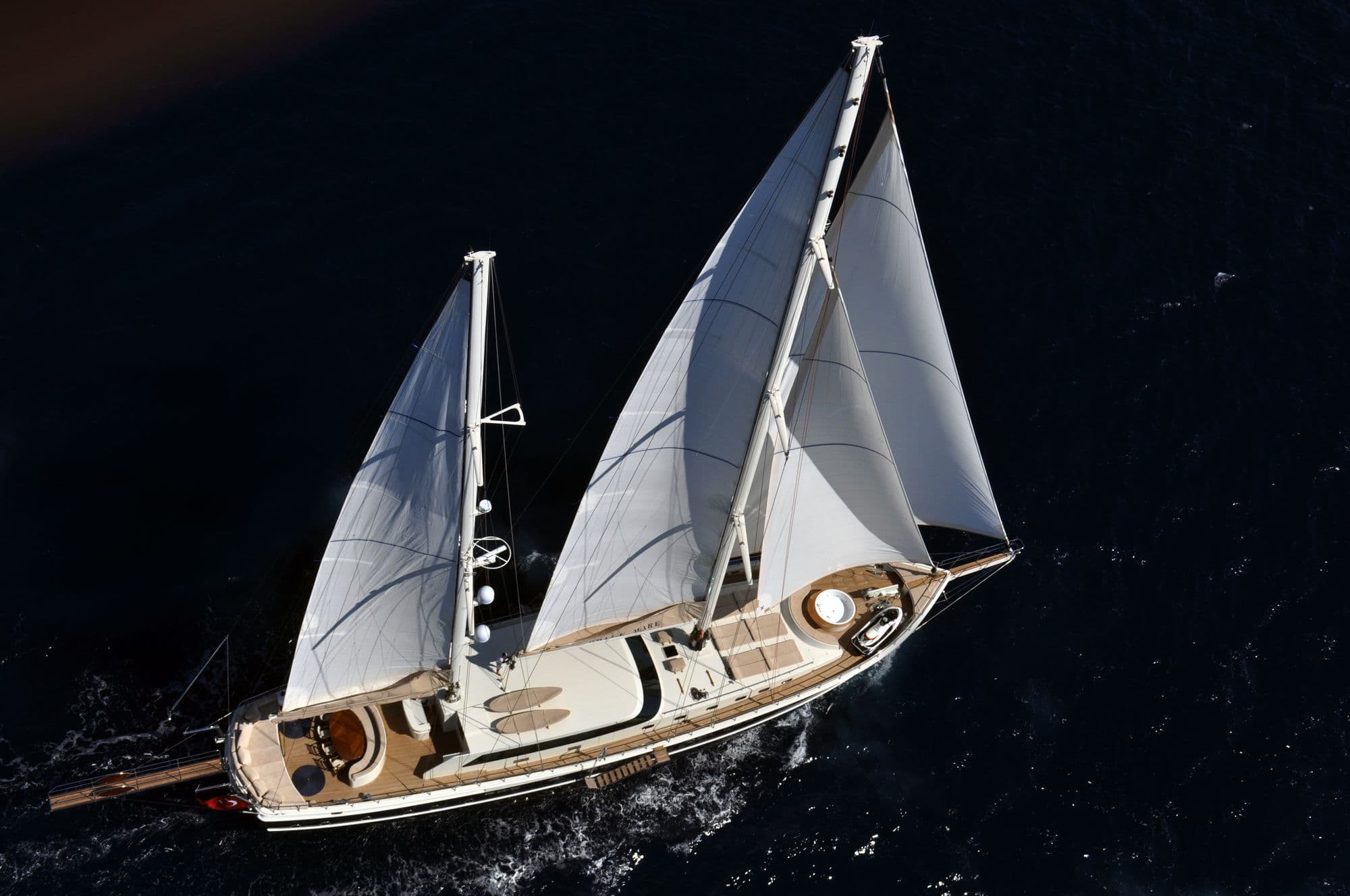 The sails and deck of Dolce Mare from the air