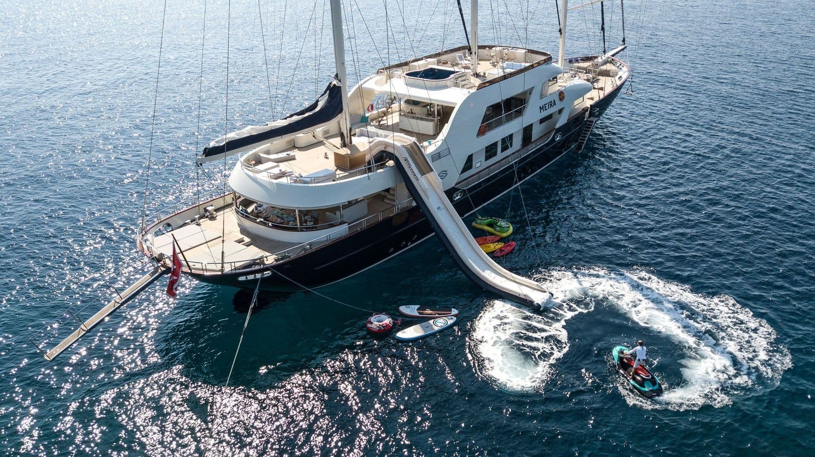Aerial view of M/S MEIRA with her sea slide and jet skis