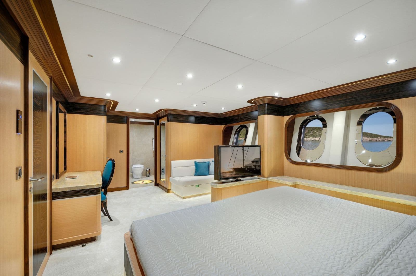 Guest cabin with portholes and a seating corner