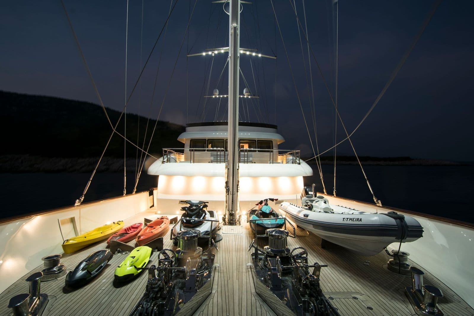 Water toys and tender on the foredeck by night