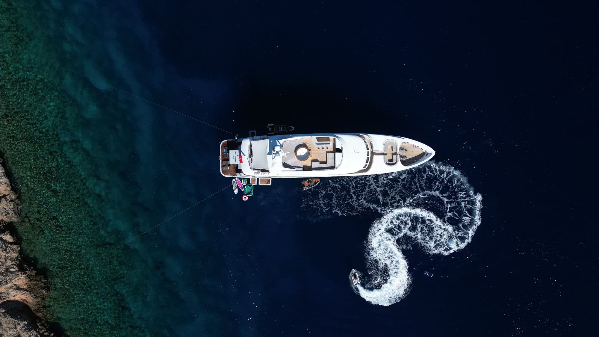 The wake of a jet ski beside M/Y PRINCESS MELDA, from the air