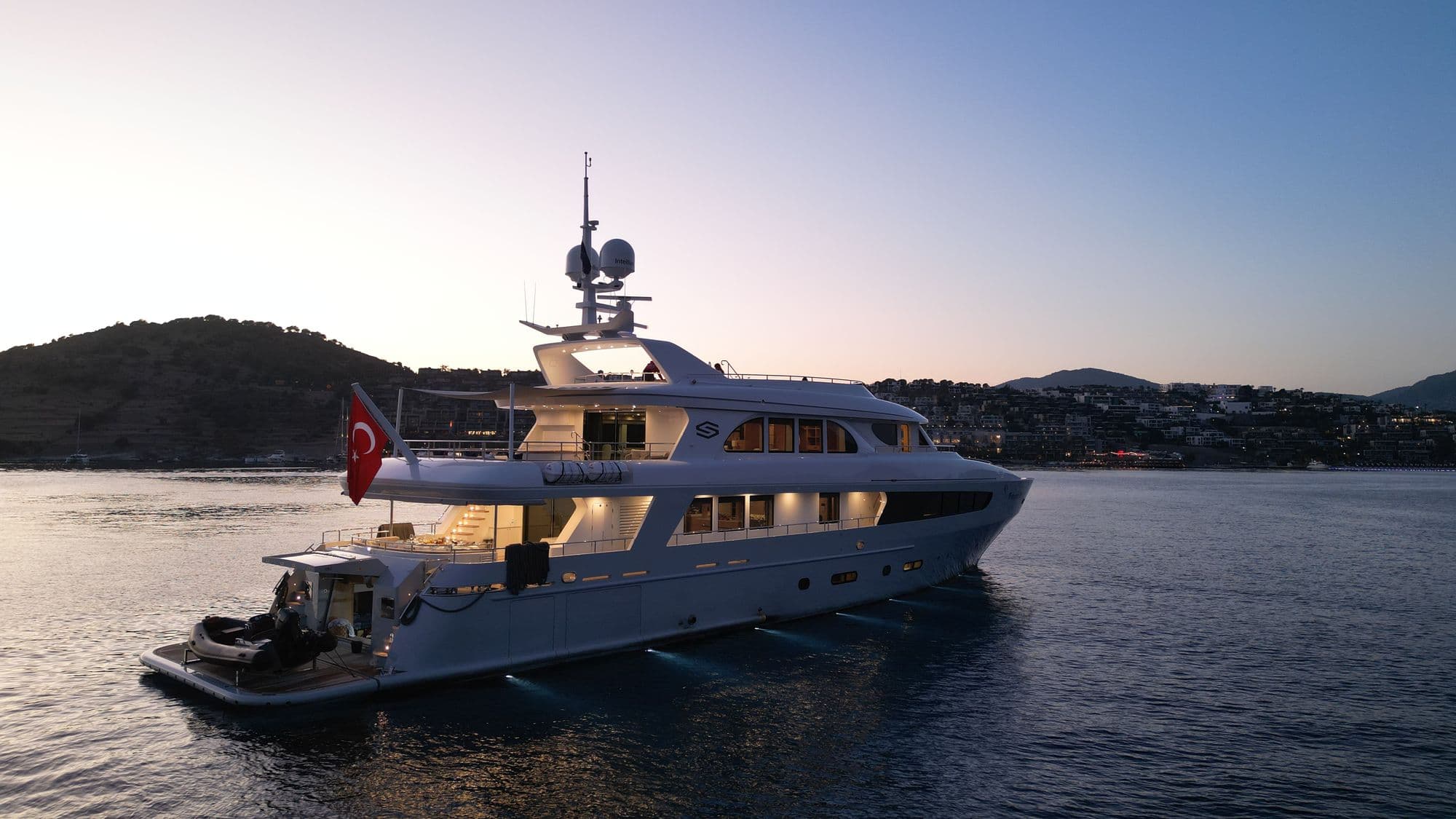 M/Y PRINCESS MELDA at anchor with her lights on at sunset