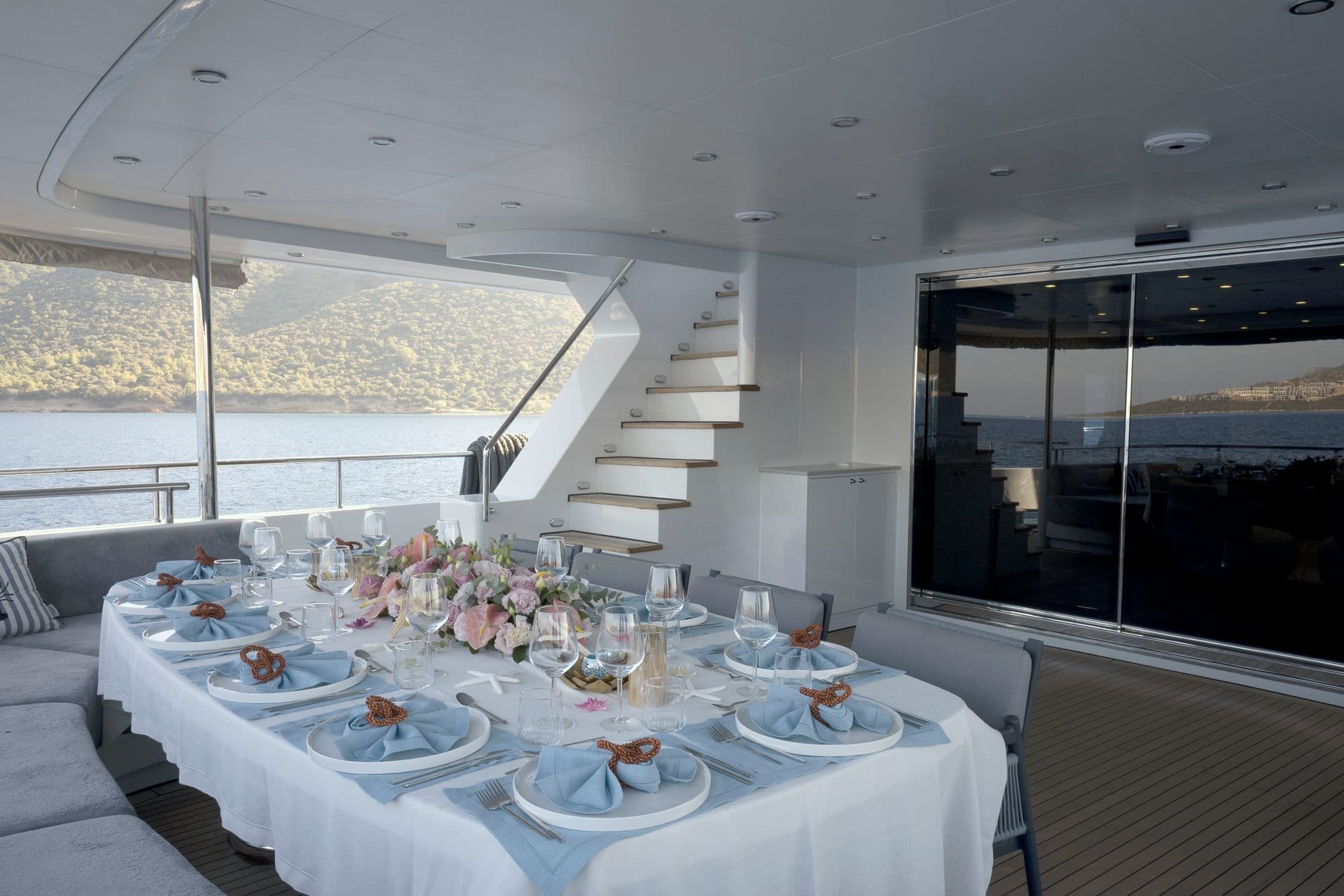 The dining table on the aft deck and the flybridge staircase