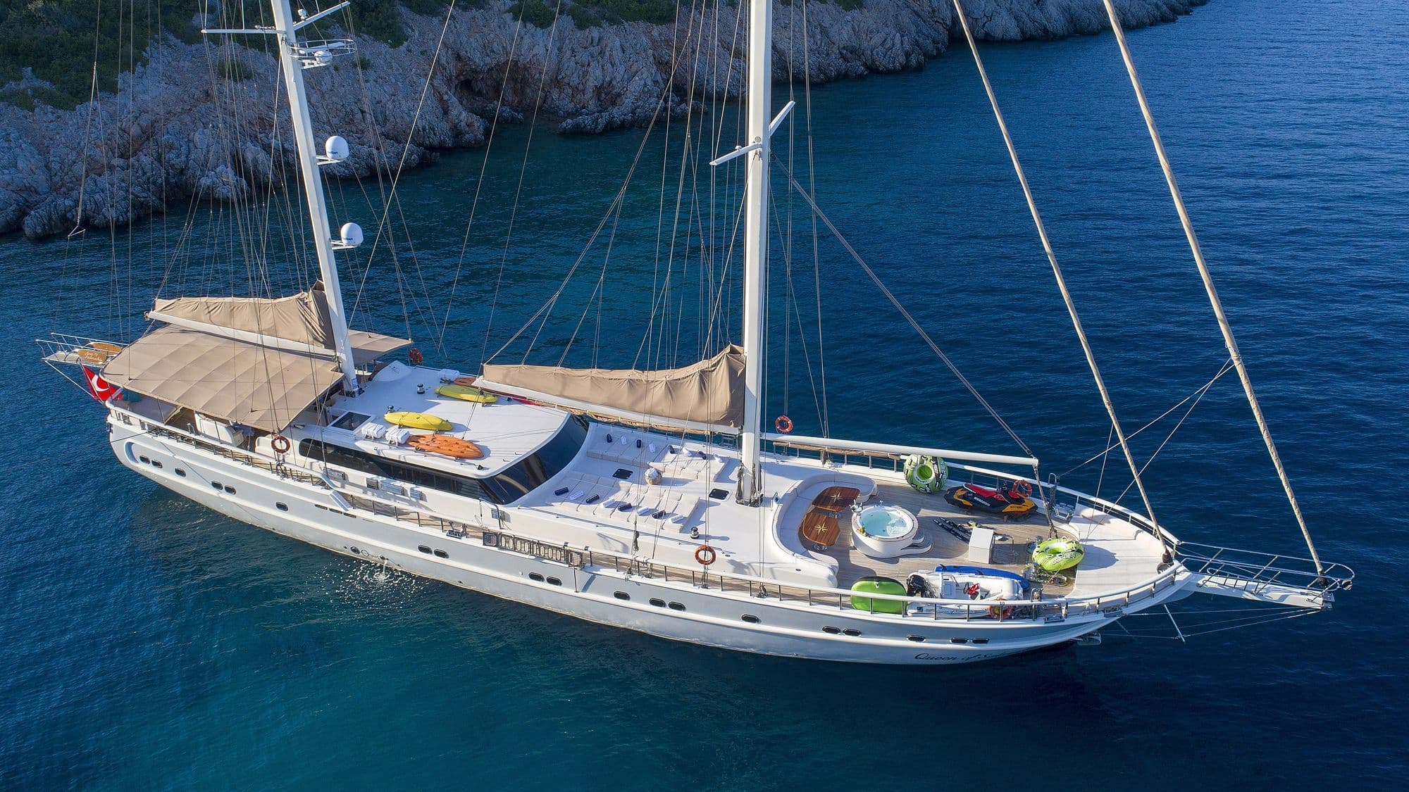 Queen of Salmakis at anchor in a rocky bay