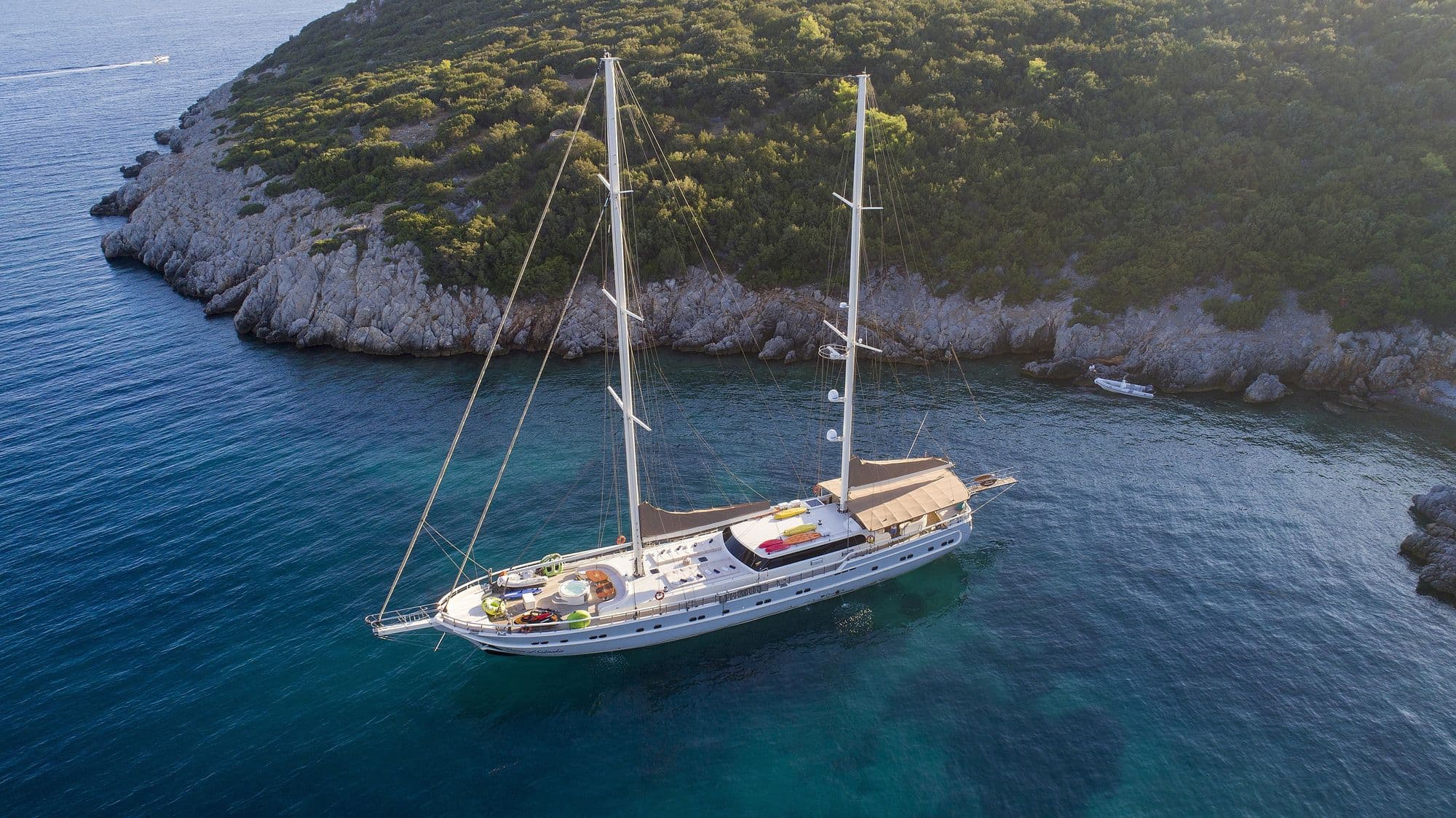 Queen of Salmakis anchored in a bay with turquoise water