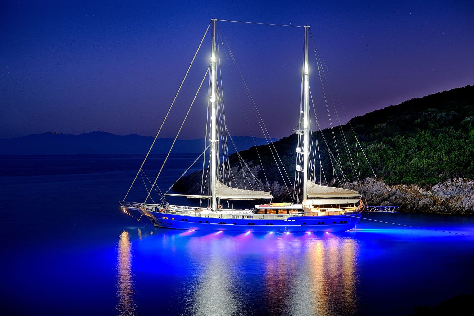 Queen of Salmakis at anchor with her lights on at night