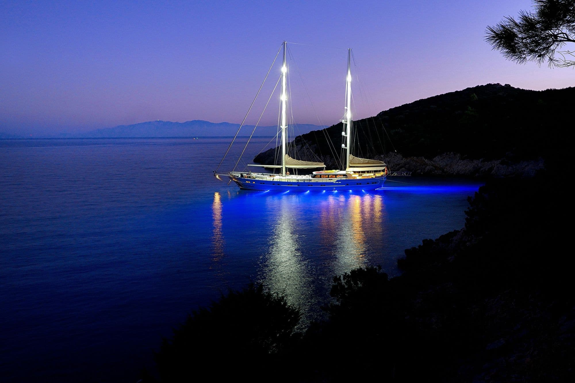 Queen of Salmakis anchored in a bay at night