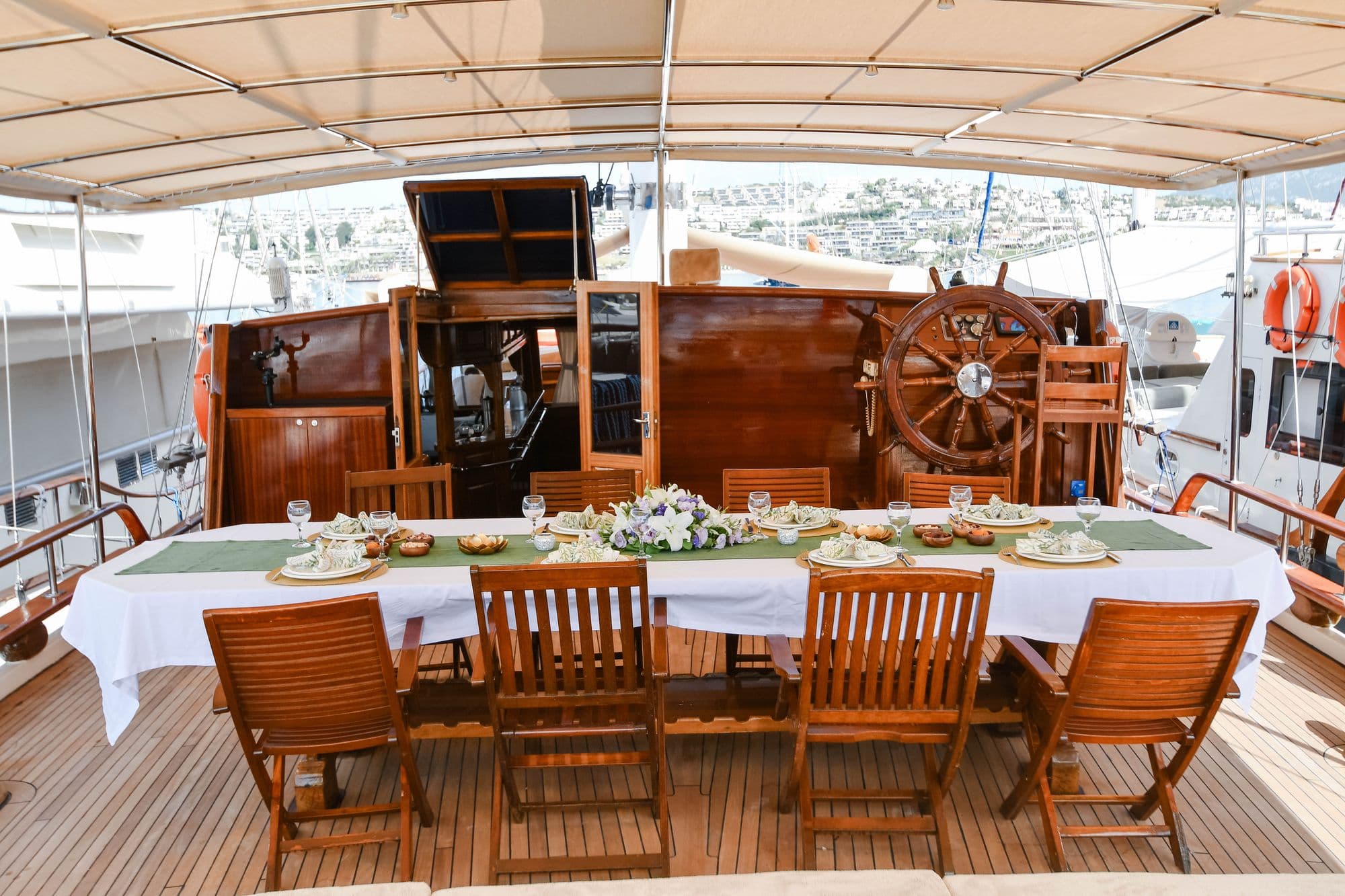 Shaded dining table and helm on the aft deck